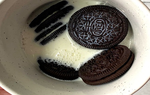 Oreo mug cake soaking in milk