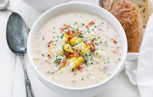 clam chowder serving with corn cob